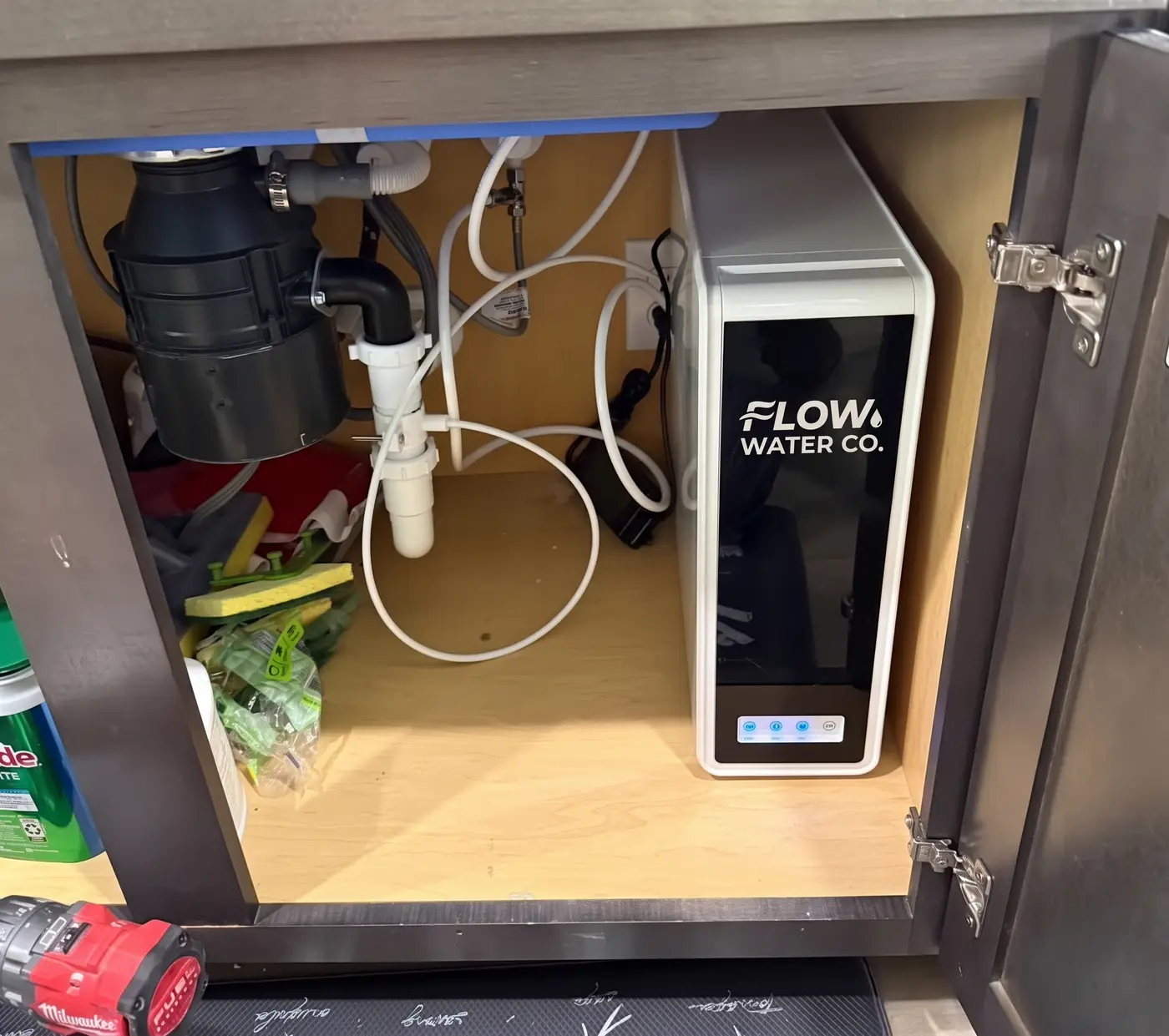 Reverse osmosis tank and fittings installed under a cabinet