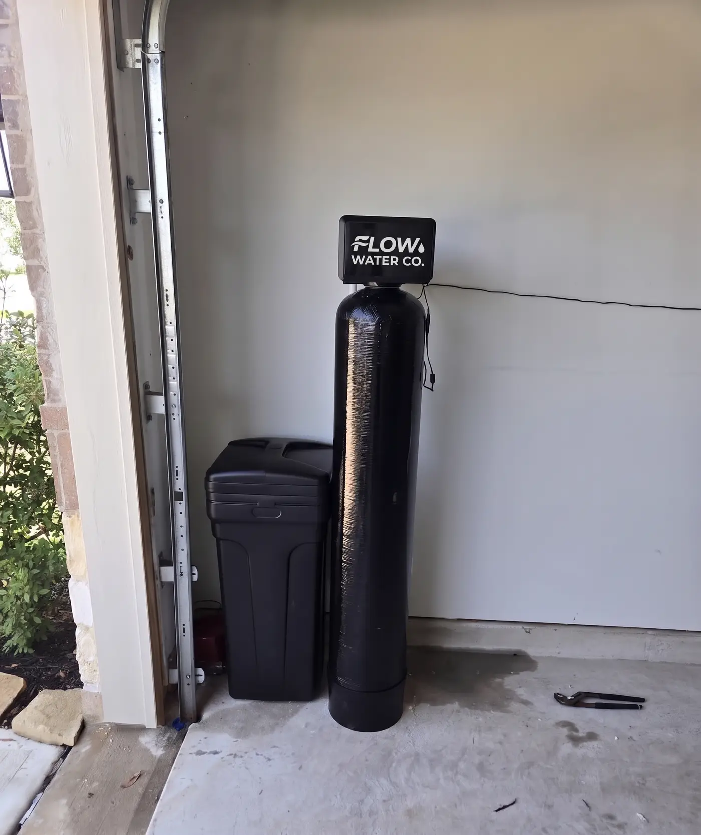 Whole-home water softener and carbon filtration system installed in a Pinellas County garage