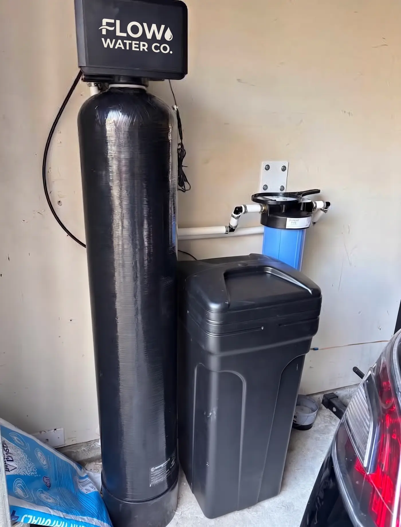 Whole-home water treatment system installed alongside a water heater