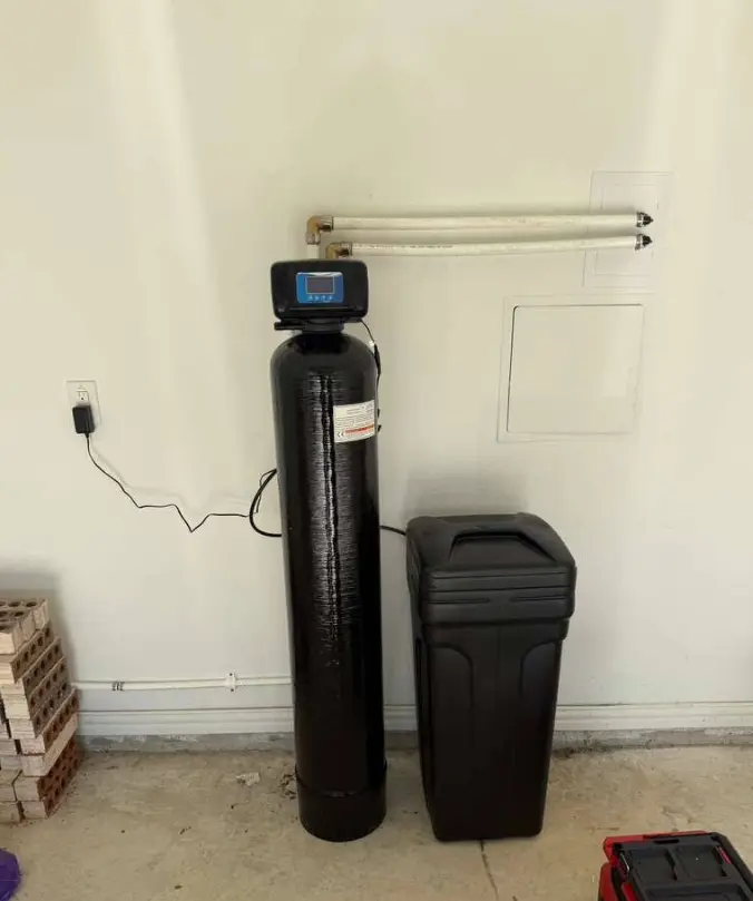 Whole-home water softener and filtration tanks side by side